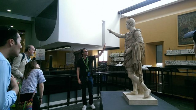 Professor Marnin Young speaks about a statue at the Vatican Museums. 