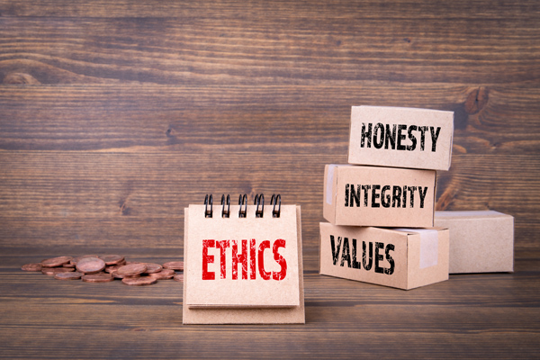 Ethics concept. Honesty, integrity and values words. Paper boxes on wooden background
