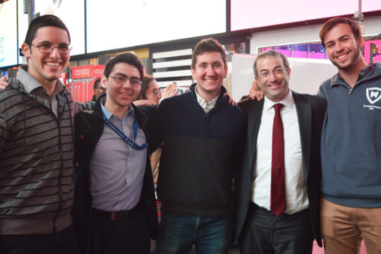Dr. Ari Berman (second from right) stands with students at the kumzitz in Times Square