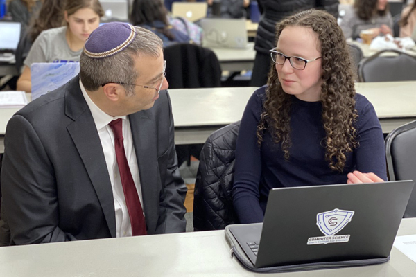 Dr. Ari Berman, President of Yeshiva University, is schooled by Etta Rapp in computer coding